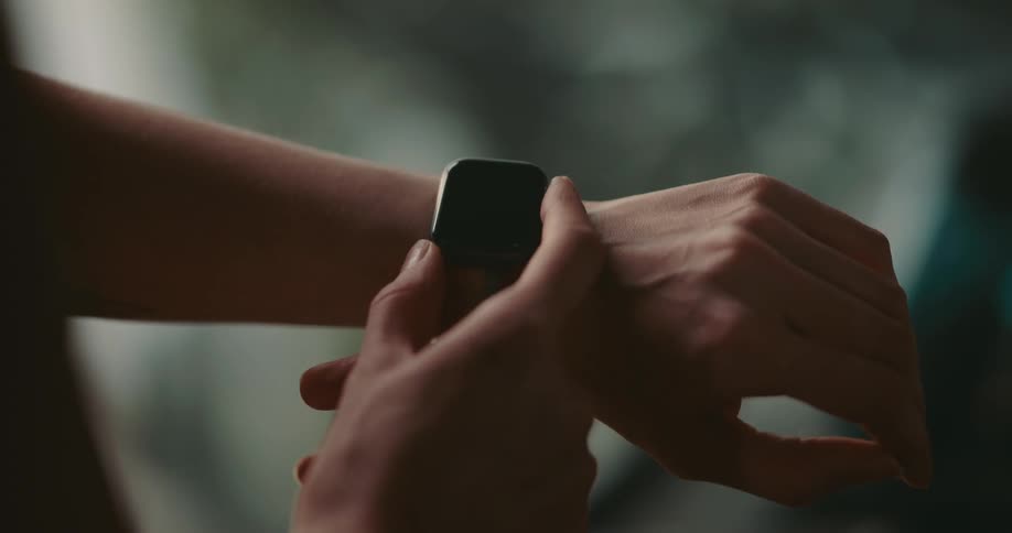 Woman uses smartwatch before working out