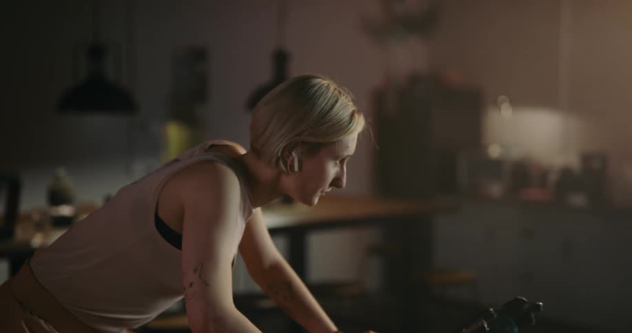 A young woman is working out inside of her home