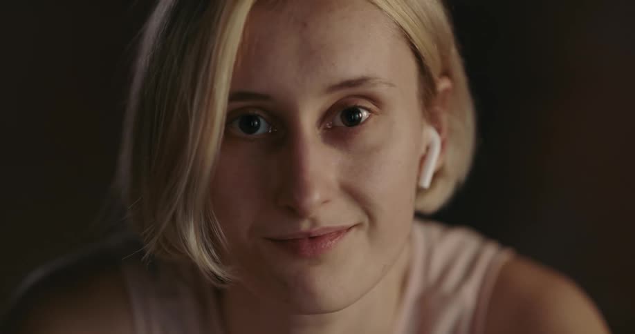 A young woman is smiling and posing for the camera