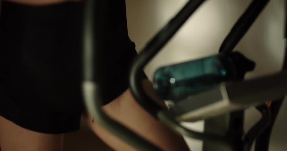 A woman running on an elliptical machine