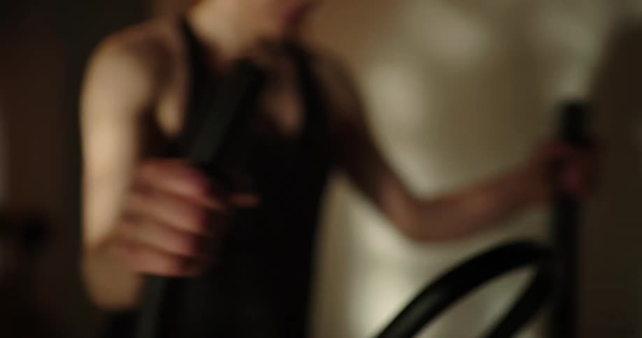 A woman works out on an elliptical machine