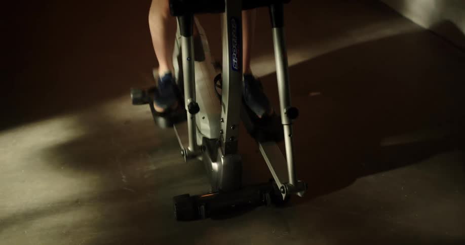 A person exercising on an elliptical machine