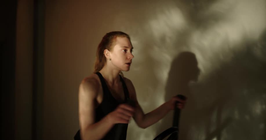A woman running on exercise equipment