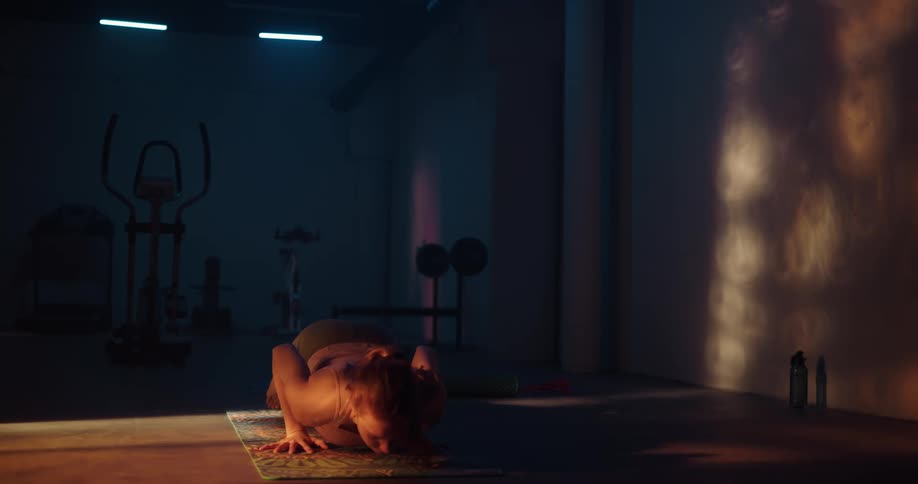A woman stretching and doing yoga on a mat