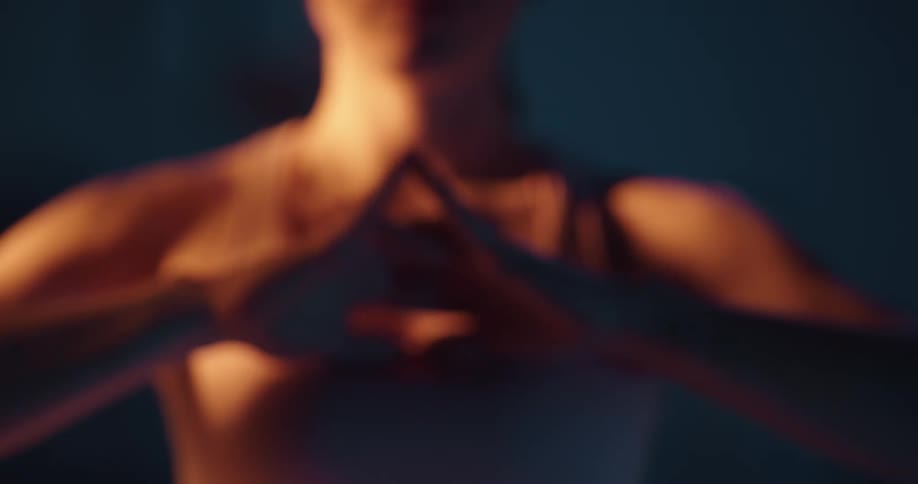 Woman interlaces her hands to stretch them in front of her