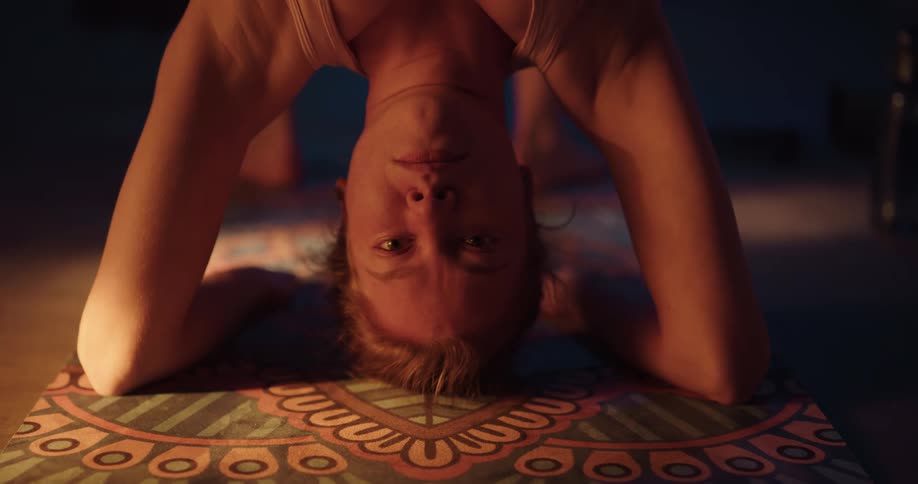 A woman stretching in a room