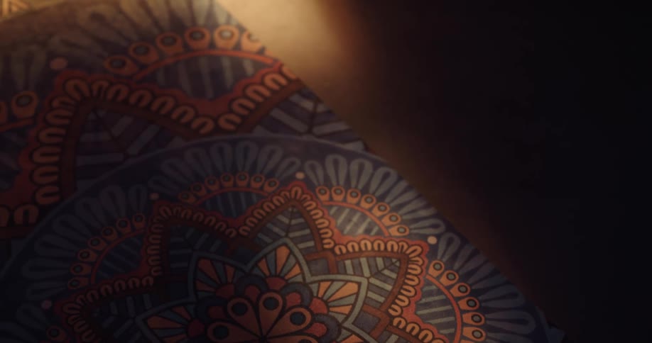A person grabbing a bottle off a rug