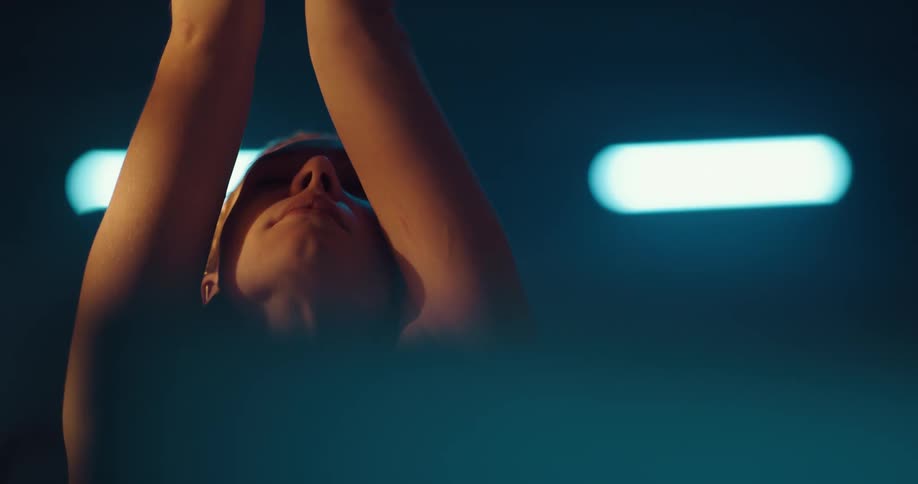 A woman stretching in a room