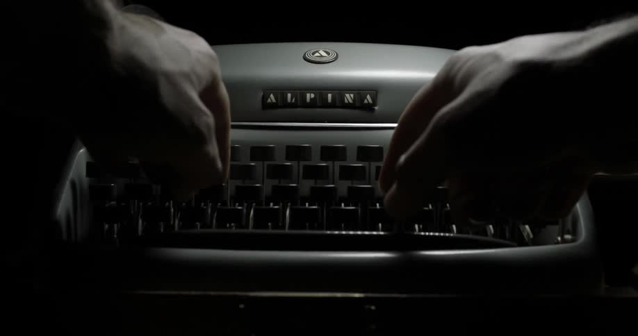 Hands type on a typing machine