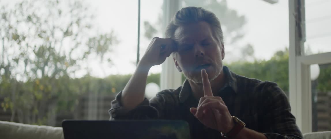 A man talks on his laptop during a video call