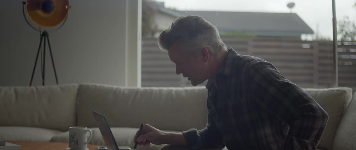 A man uses his laptop for a video call at home