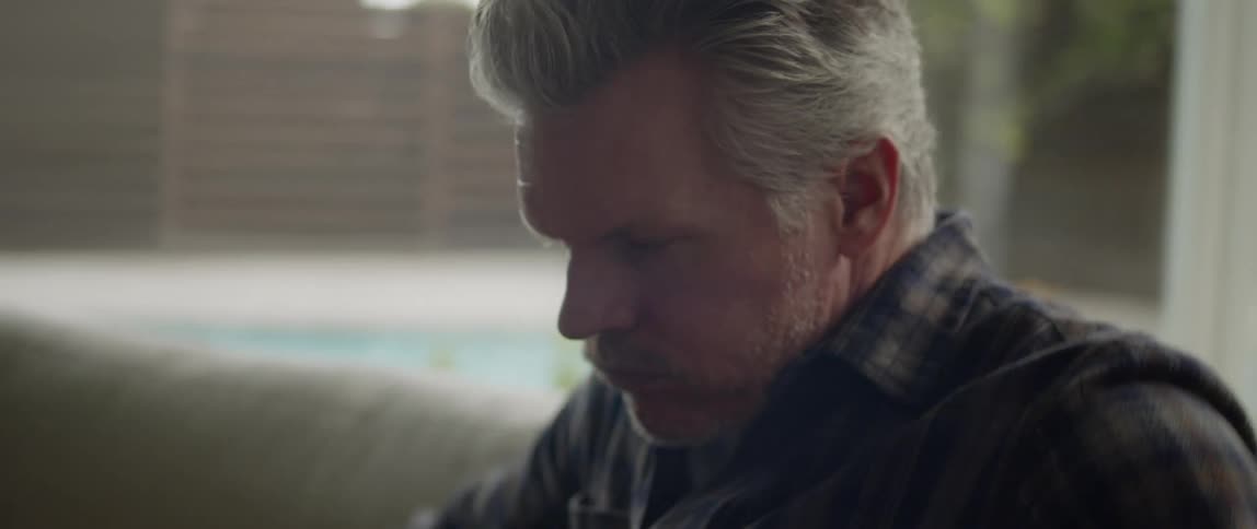 Older man sighs and leans back instead of continuing to get to his feet