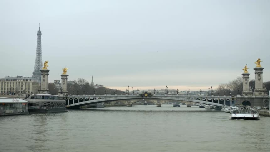 Vehicles travel over a canal bridge in paris
