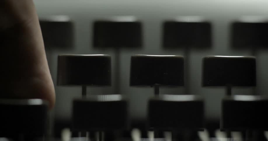 Someone pushing buttons on a typewriter
