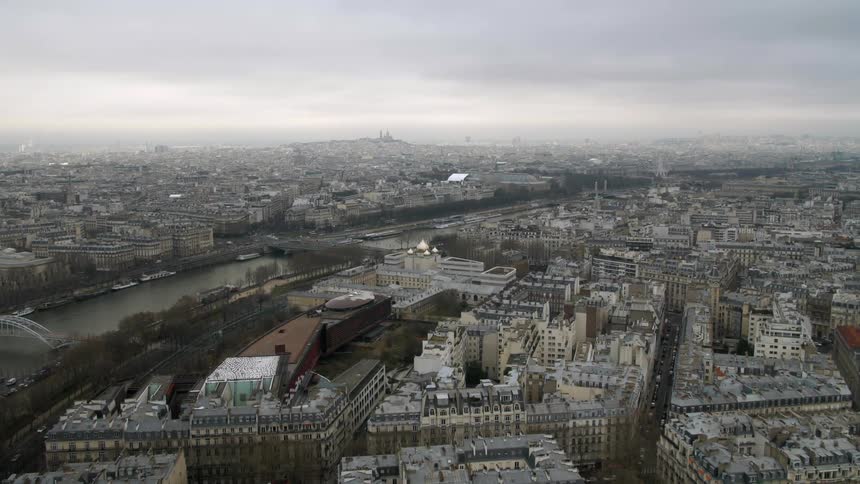 A large city has a canal with a bridge below
