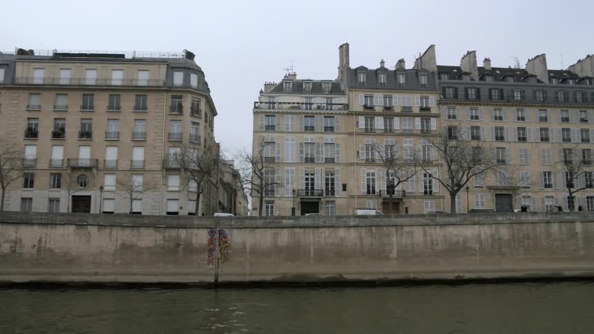 Sailing along a river past buildings