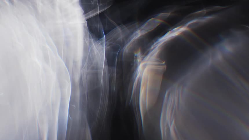 Light flashes on orbs of smoke creating colorful trails