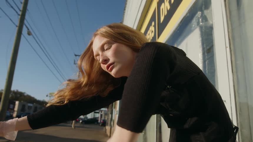 A young woman is moving and posing for the camera