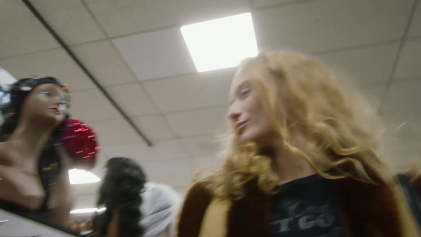 A young woman is walking around into the store