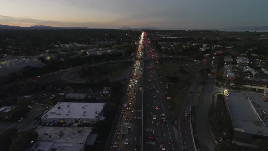 Heavy traffic flows on a freeway that runs through a city