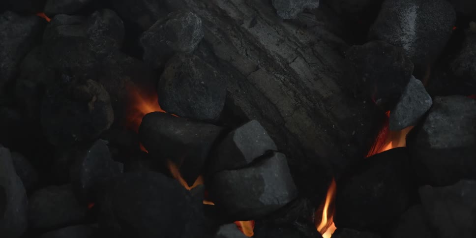 Flames burning as charcoal falls