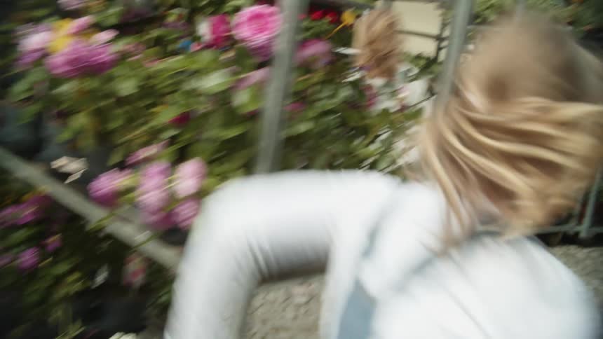 A daughter chasing her mother around a flower shop