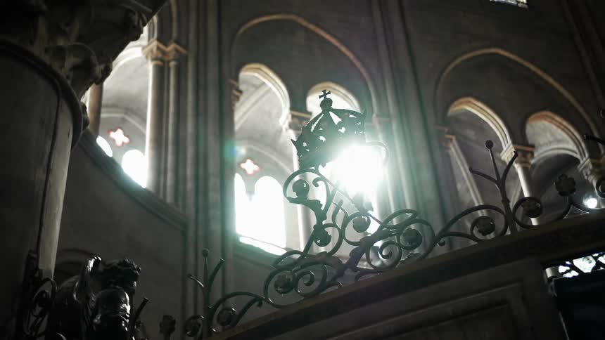 A church has arched windows with stained glass
