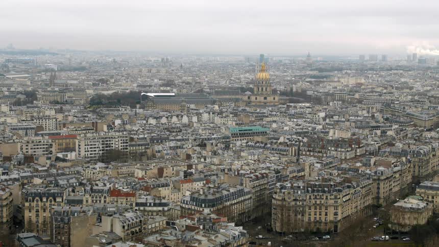 A large city is below with a cloudy sky