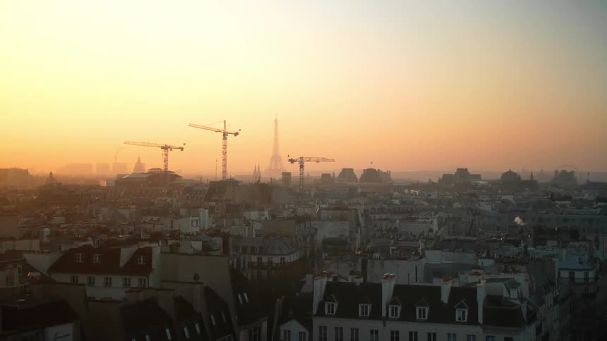 The sun rises over a city