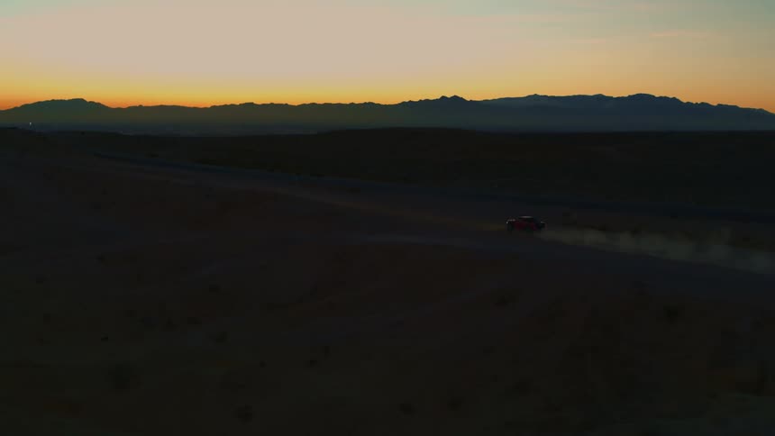 Tracking shot of backlit Baja Truck in Desert at sunset