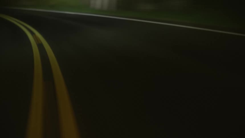 Vehicle drives on highway at night