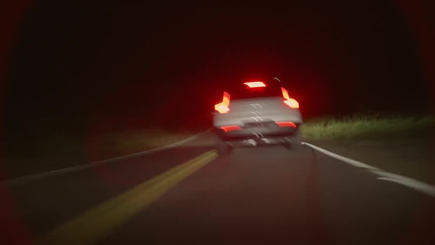 White 4x4 drives on highway at night