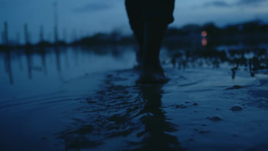 A person walking outdoors in water