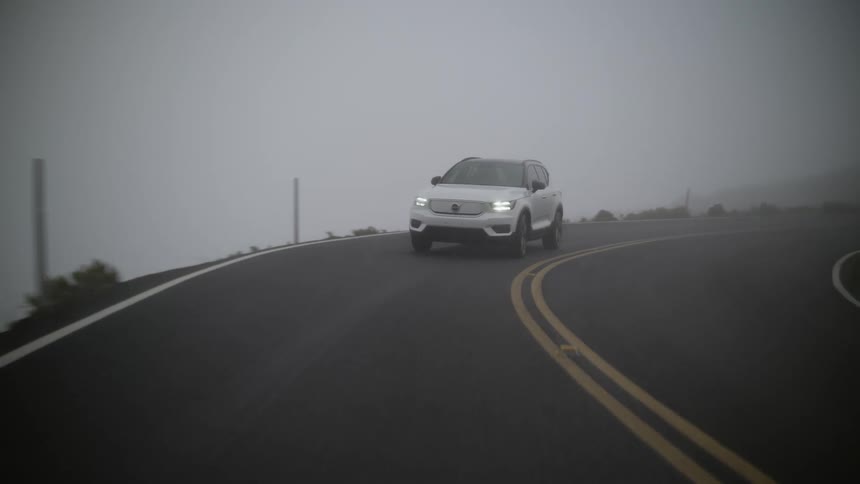 A vehicle drives along a curve in the road