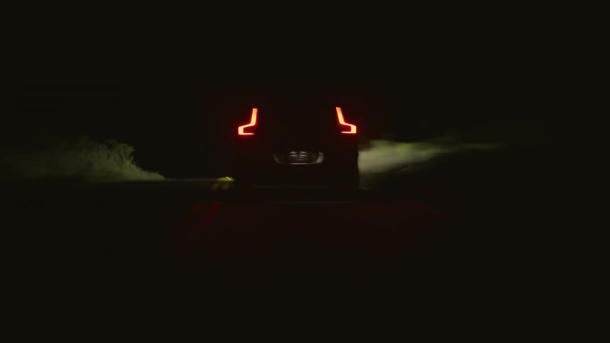 4x4 car drives on country road at night