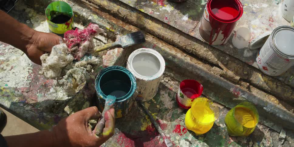 A person is painting inside of there home in the day time