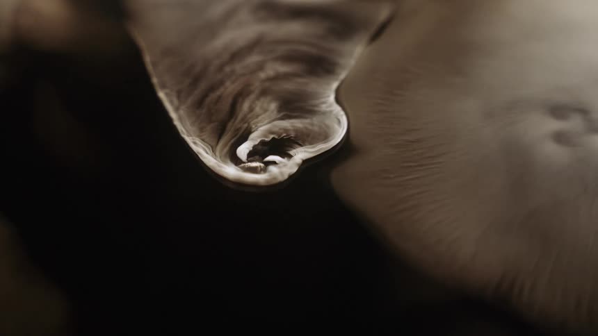 A spinning object moves across the surface like a cyclone leaving a trail as it moves