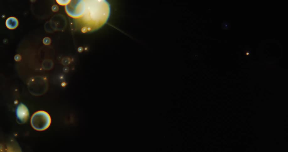 Glowing orbs of light twinkle as they move and shine in the darkness