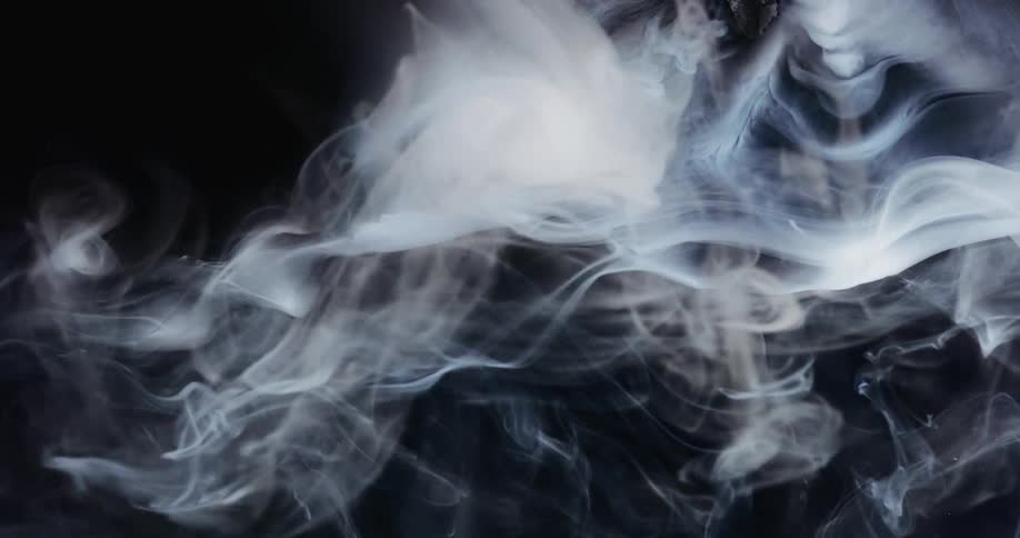 White smoke swirling in darkness