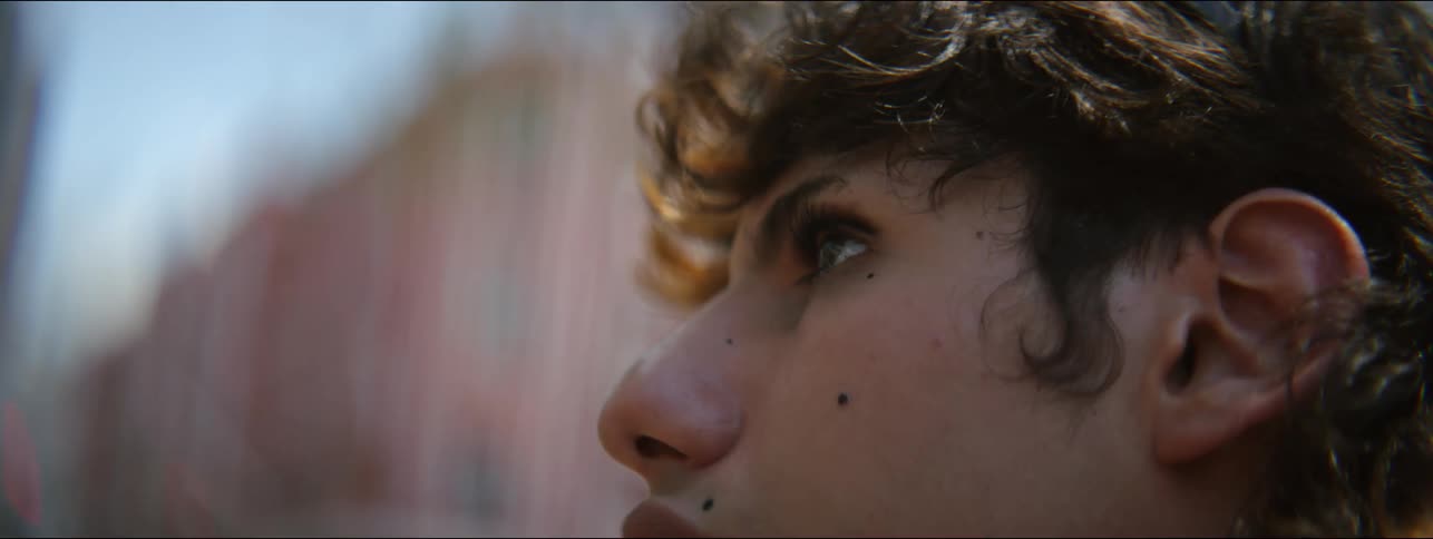 Close up of a teenager outside looking in to the distance