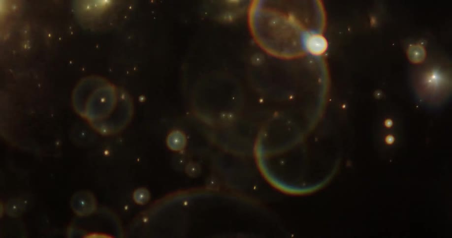 Bubbles of colorful lights moving quickly in darkness