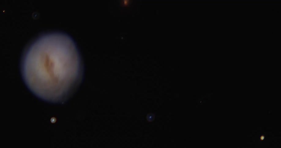 Shimmering spheres fall against a black background