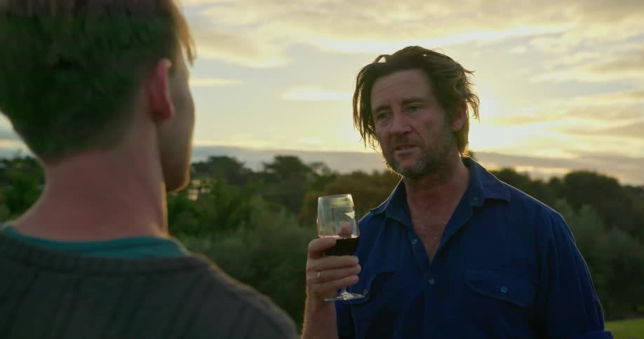 Two men drinking wine and speaking
