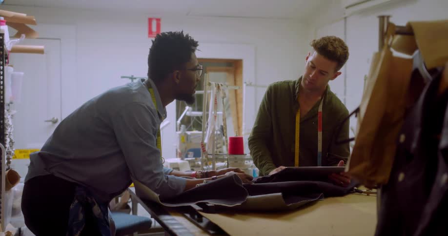 Two fashion designers talk while at work