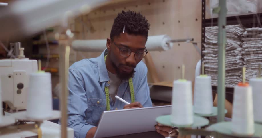 A fashion designer works on a tablet
