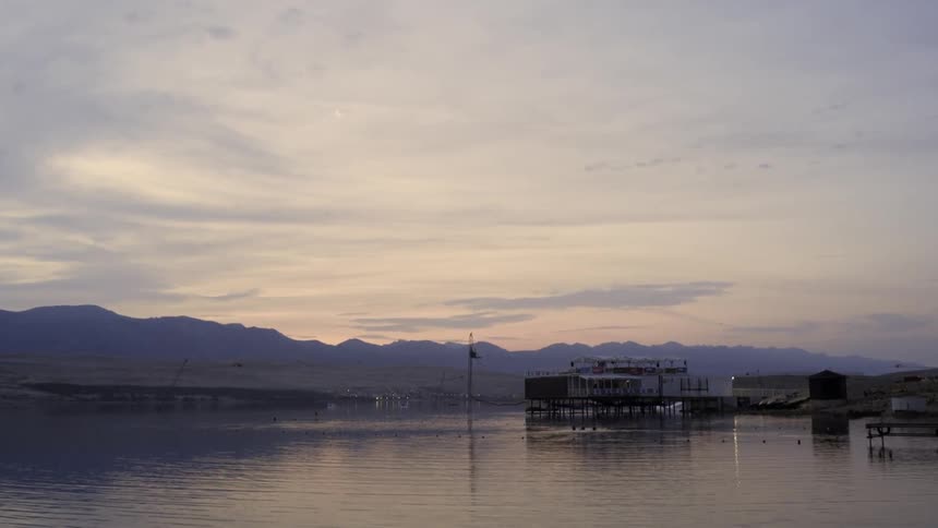 Clouds hovering over a mountain range and large body of water