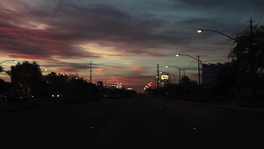 Traffic flowing along a highway at sunset