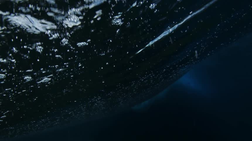 A large wave crashes in the ocean