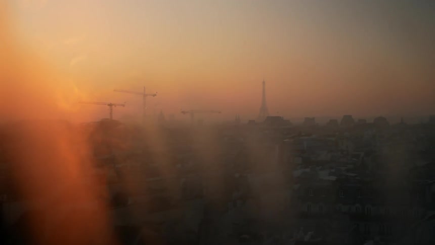 The sun sets through a foggy window