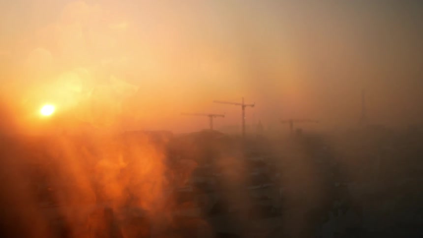 The sun shines through a steamy and wet window